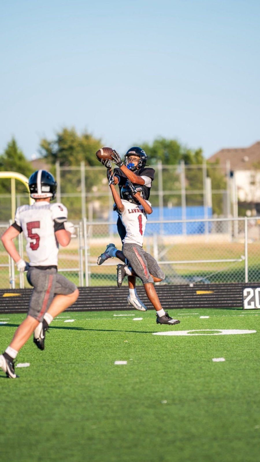 Edje Jackson going up for a contested pass in a football game